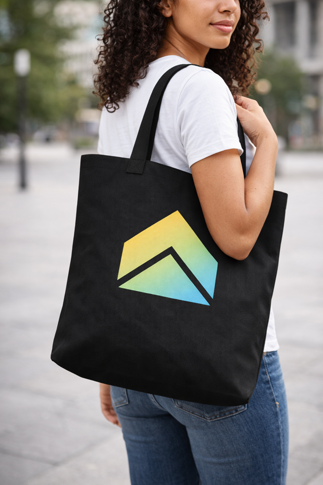 UpStart black canvas tote bag with gradient arrow logo, Model Wearing Tote (White Tee)