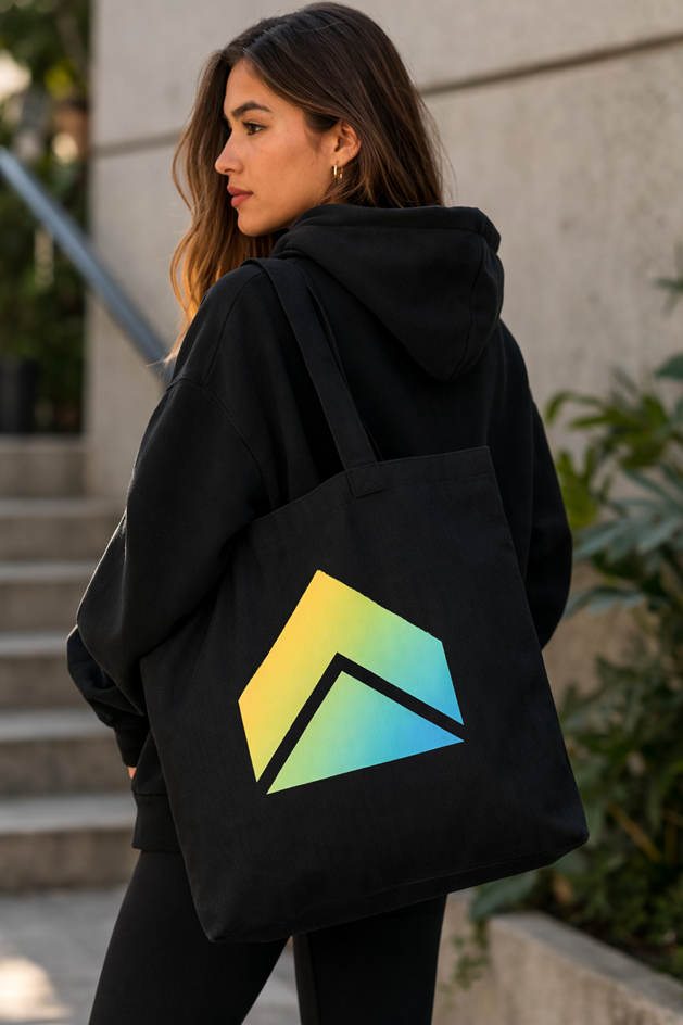 UpStart black canvas tote bag with gradient arrow logo Model Wearing Tote (Black Hoodie)
